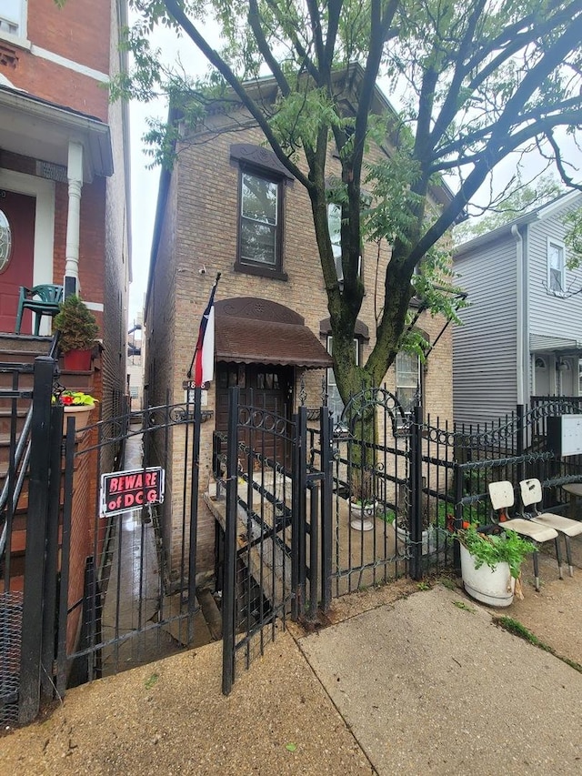 1838 S Laflin St, Chicago, IL 60608 - view of front facade featuring a gate, brick siding, and a fenced front yard