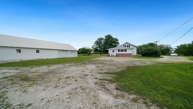 18521 Anderson Rd, Prophetstown, IL 61277 - view of grassy yard featuring a detached garage and an outbuilding
