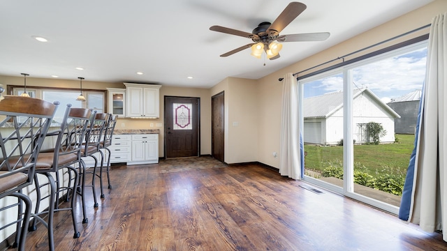 18521 Anderson Rd, Prophetstown, IL 61277 - kitchen featuring healthy amount of natural light, dark wood finished floors, decorative light fixtures, glass insert cabinets, and recessed lighting