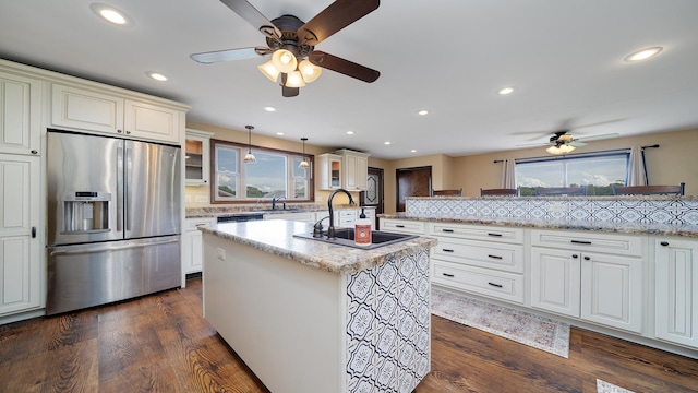 18521 Anderson Rd, Prophetstown, IL 61277 - kitchen featuring stainless steel fridge, a ceiling fan, glass insert cabinets, a kitchen island with sink, and pendant lighting