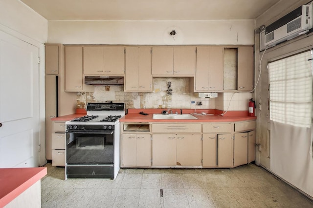 1532 E 59th St Unit J3, Chicago, IL 60637 - kitchen with range with gas stovetop, under cabinet range hood, cream cabinetry, and tasteful backsplash