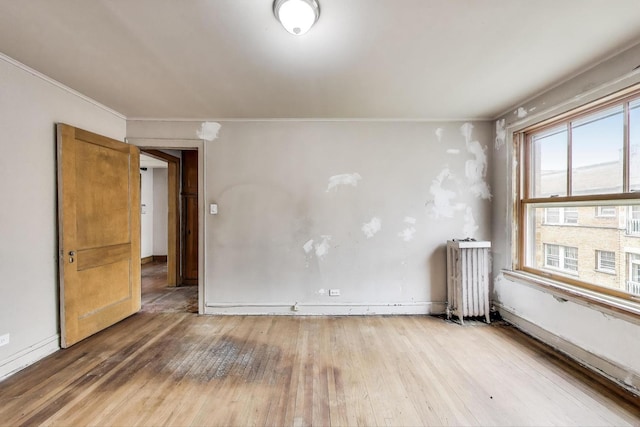 1532 E 59th St Unit J3, Chicago, IL 60637 - unfurnished room with radiator heating unit, hardwood / wood-style flooring, and ornamental molding