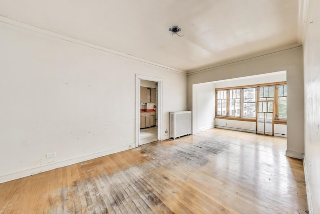 1532 E 59th St Unit J3, Chicago, IL 60637 - spare room with radiator heating unit, ornamental molding, and wood-type flooring