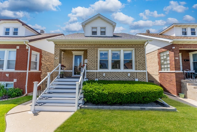 2610 N Major Ave, Chicago, IL 60639 - bungalow-style home featuring brick siding, a porch, a shingled roof, and a front yard
