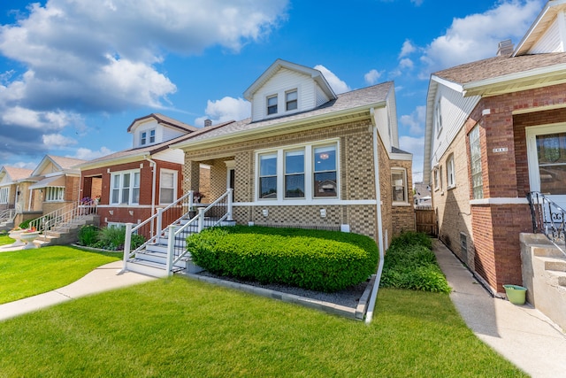 2610 N Major Ave, Chicago, IL 60639 - bungalow-style home with brick siding and a front lawn