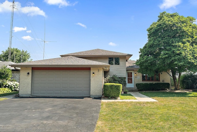 5551 143rd St, Midlothian, IL 60445 - split level home featuring brick siding, asphalt driveway, a front lawn, and a garage