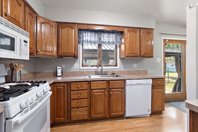 5551 143rd St, Midlothian, IL 60445 - kitchen featuring white appliances, brown cabinets, light countertops, and light wood-style flooring