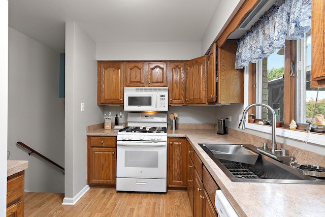 5551 143rd St, Midlothian, IL 60445 - kitchen featuring white appliances, brown cabinets, light wood finished floors, and light countertops
