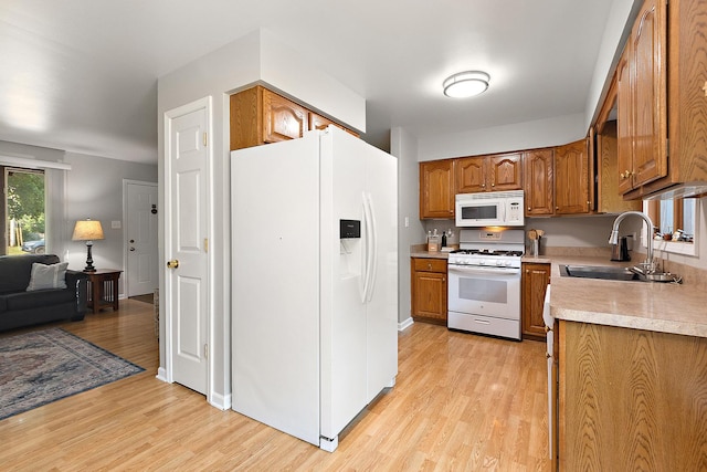 5551 143rd St, Midlothian, IL 60445 - kitchen with white appliances, brown cabinetry, light wood-style floors, light countertops, and open floor plan