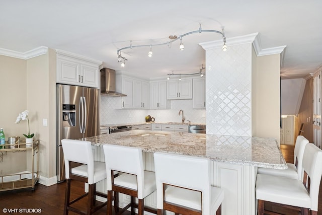 1500 Sheridan Rd Unit 7G, Wilmette, IL 60091 - kitchen with wall chimney exhaust hood, appliances with stainless steel finishes, a kitchen bar, dark wood finished floors, and crown molding