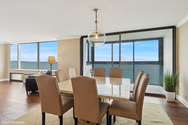 1500 Sheridan Rd Unit 7G, Wilmette, IL 60091 - dining space featuring expansive windows, plenty of natural light, hardwood / wood-style floors, a water view, and ornamental molding
