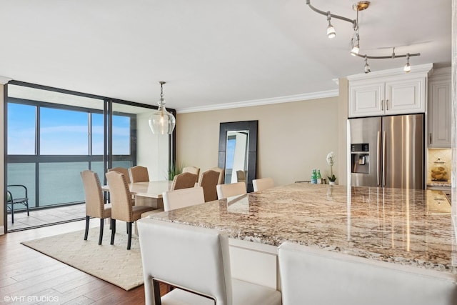 1500 Sheridan Rd Unit 7G, Wilmette, IL 60091 - dining area with wood finished floors, a water view, ornamental molding, and a wall of windows