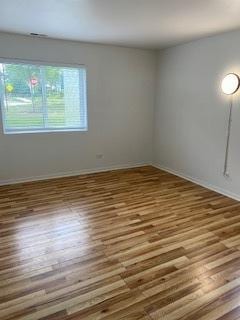 1486 Stonebridge Cir Unit A3, Wheaton, IL 60189 - unfurnished room featuring wood finished floors and baseboards