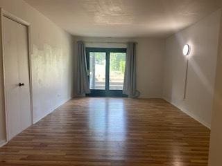 1486 Stonebridge Cir Unit A3, Wheaton, IL 60189 - spare room featuring wood finished floors