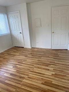 1486 Stonebridge Cir Unit A3, Wheaton, IL 60189 - unfurnished bedroom with wood finished floors and a closet