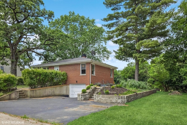 200 Eastwood Ct, Port Barrington, IL 60010 - view of side of home featuring asphalt driveway, an attached garage, a chimney, brick siding, and a yard