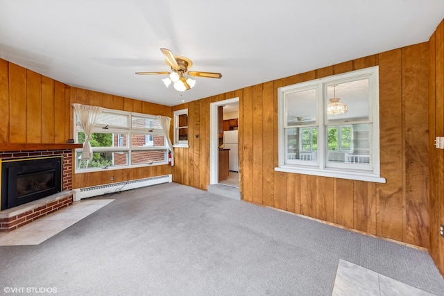 200 Eastwood Ct, Port Barrington, IL 60010 - unfurnished living room with a baseboard radiator, carpet, wooden walls, ceiling fan, and a fireplace