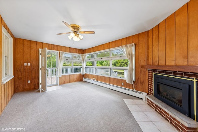 200 Eastwood Ct, Port Barrington, IL 60010 - unfurnished living room with a baseboard radiator, ceiling fan, a fireplace, wood walls, and carpet floors