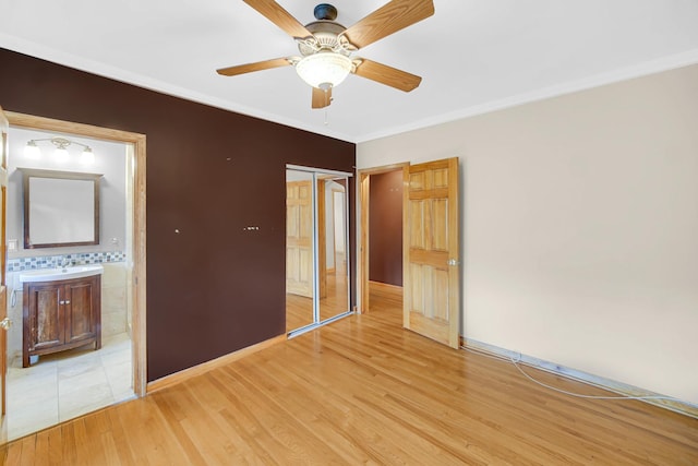 10911 S Longwood Dr Unit 2, Chicago, IL 60643 - unfurnished bedroom with a closet, light wood-type flooring, ornamental molding, and a ceiling fan