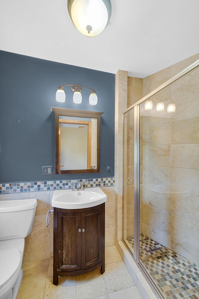 10911 S Longwood Dr Unit 2, Chicago, IL 60643 - bathroom featuring tile walls, a stall shower, vanity, wainscoting, and tile patterned floors
