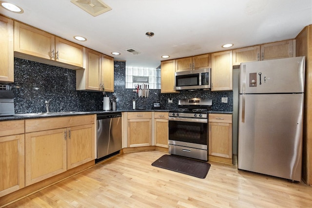 4744 S Prairie Ave Unit 1A, Chicago, IL 60615 - kitchen with stainless steel appliances, dark countertops, light wood-style floors, light brown cabinetry, and tasteful backsplash