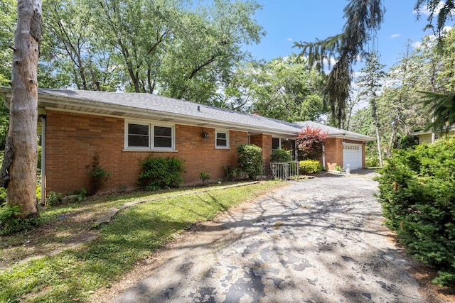 7942 Tennessee Ave, Willowbrook, IL 60527 - view of front of property featuring a garage, brick siding, and driveway