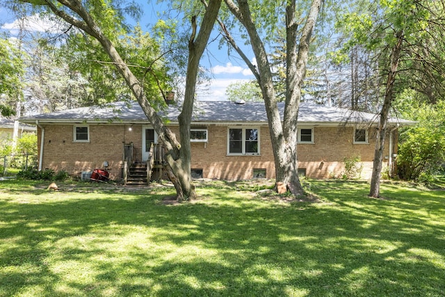 7942 Tennessee Ave, Willowbrook, IL 60527 - back of house with brick siding and a lawn