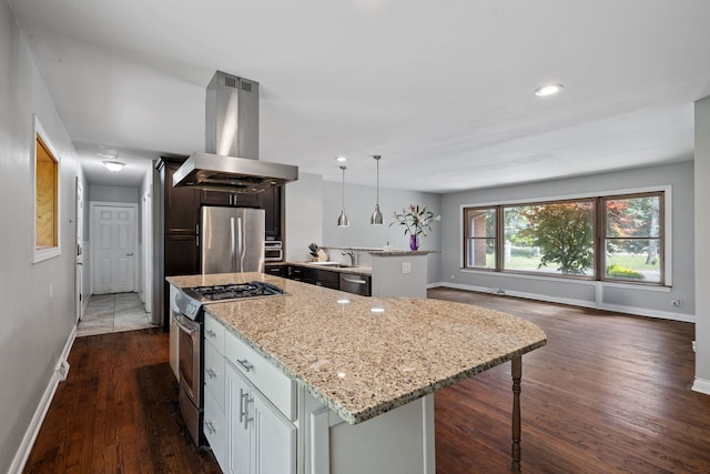 7942 Tennessee Ave, Willowbrook, IL 60527 - kitchen featuring island exhaust hood, appliances with stainless steel finishes, dark wood finished floors, light stone counters, and a center island