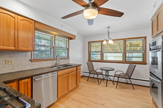 3104 Maple St, Franklin Park, IL 60131 - kitchen with stainless steel appliances, a baseboard radiator, decorative backsplash, light wood-type flooring, and ceiling fan