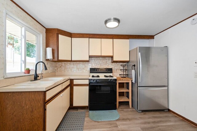 8882 S Main St, Hometown, IL 60456 - kitchen featuring freestanding refrigerator, white range with gas stovetop, light countertops, decorative backsplash, and light wood finished floors