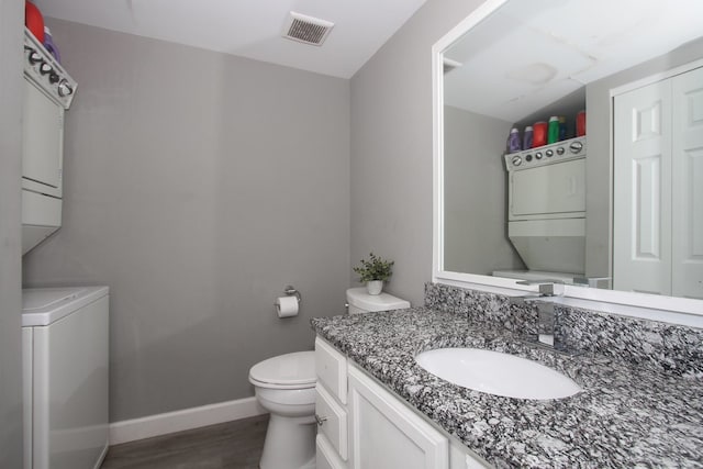 446 Northampton Ln, Roselle, IL 60172 - half bath featuring estacked washer and dryer, vanity, and wood finished floors