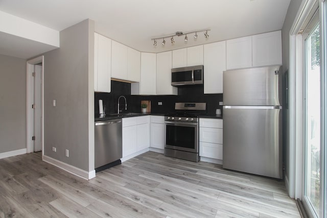 446 Northampton Ln, Roselle, IL 60172 - kitchen with stainless steel appliances, dark countertops, decorative backsplash, and white cabinets
