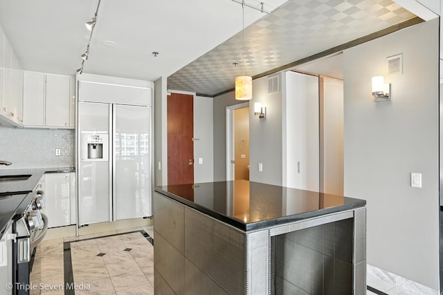 100 E Huron St Unit 2301, Chicago, IL 60611 - kitchen featuring paneled refrigerator, dark countertops, stainless steel electric stove, and white cabinets
