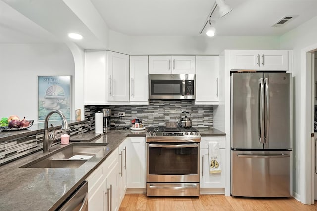 11315 Sycamore Ln Unit B, Palos Hills, IL 60465 - kitchen featuring stainless steel appliances, dark stone counters, white cabinetry, and decorative backsplash