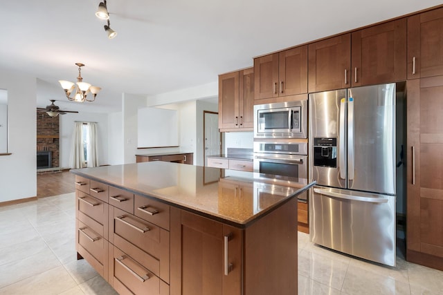 775 Harmon Blvd, Hoffman Estates, IL 60169 - kitchen with appliances with stainless steel finishes, a chandelier, light tile patterned floors, ceiling fan, and a center island