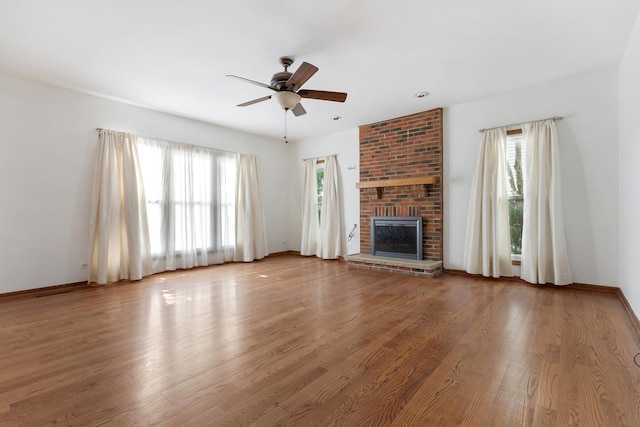 775 Harmon Blvd, Hoffman Estates, IL 60169 - unfurnished living room featuring healthy amount of natural light, a ceiling fan, a fireplace, and wood finished floors