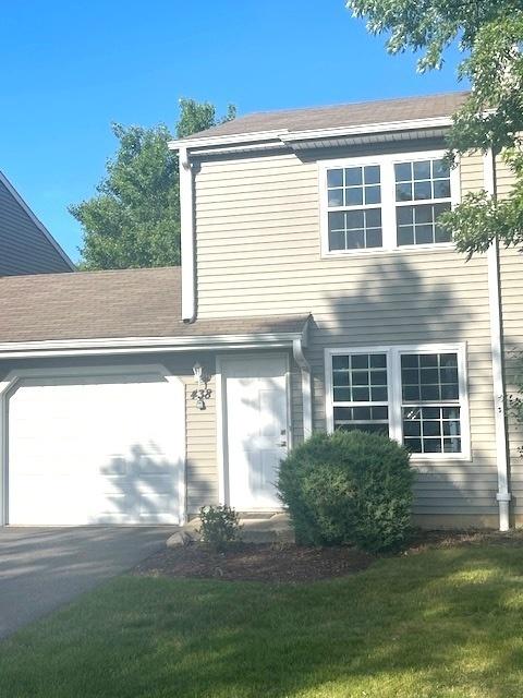438 Meadow Hill Ln, Round Lake Beach, IL 60073 - view of side of property with a garage and driveway