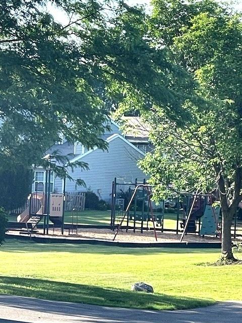 438 Meadow Hill Ln, Round Lake Beach, IL 60073 - surrounding community featuring a lawn