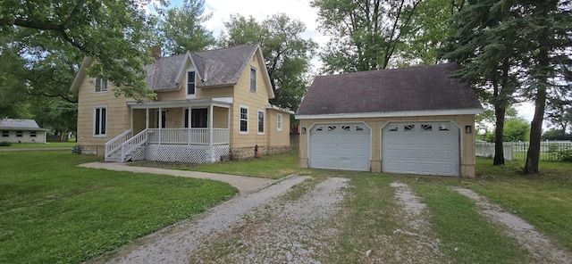 401 N 2nd Ave, Chenoa, IL 61726 - view of front facade featuring an outdoor structure, a garage, and a porch