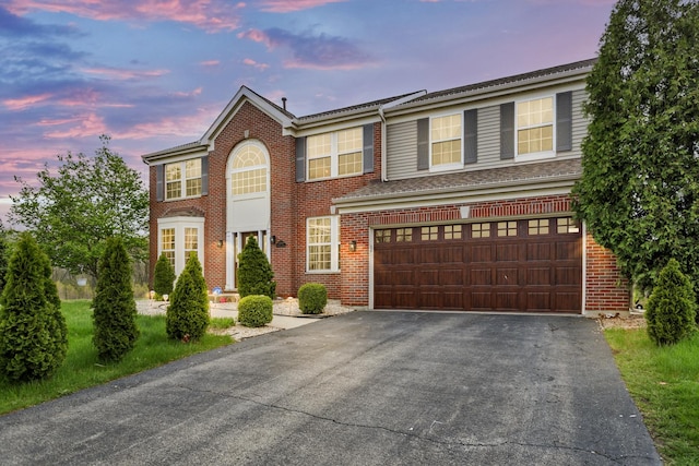 22600 W Reserve Cir, Plainfield, IL 60544 - view of front of house featuring driveway, an attached garage, and brick siding