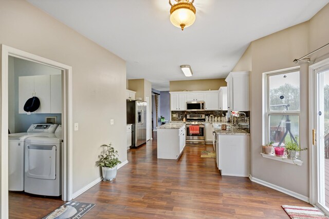 22600 W Reserve Cir, Plainfield, IL 60544 - kitchen featuring stainless steel appliances, separate washer and dryer, dark wood-type flooring, white cabinetry, and a center island