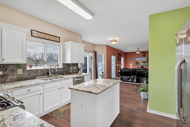 22600 W Reserve Cir, Plainfield, IL 60544 - kitchen with backsplash, a kitchen island, open floor plan, white cabinets, and appliances with stainless steel finishes