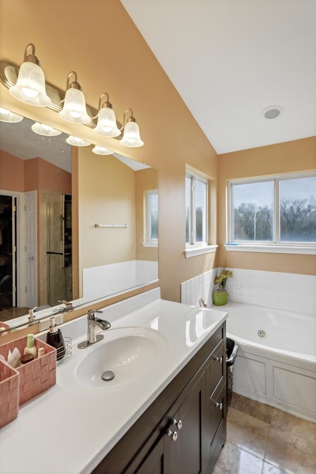22600 W Reserve Cir, Plainfield, IL 60544 - bathroom featuring a garden tub, vanity, vaulted ceiling, an enclosed shower, and tile patterned flooring