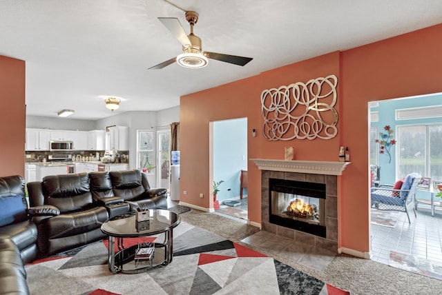22600 W Reserve Cir, Plainfield, IL 60544 - living room with ceiling fan, a tile fireplace, light carpet, and light tile patterned floors