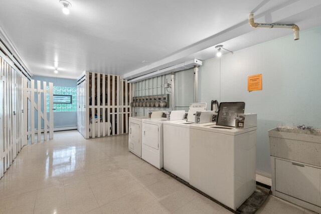 950 Washington Blvd Unit 206, Oak Park, IL 60302 - community laundry room with washer and dryer and a baseboard heating unit