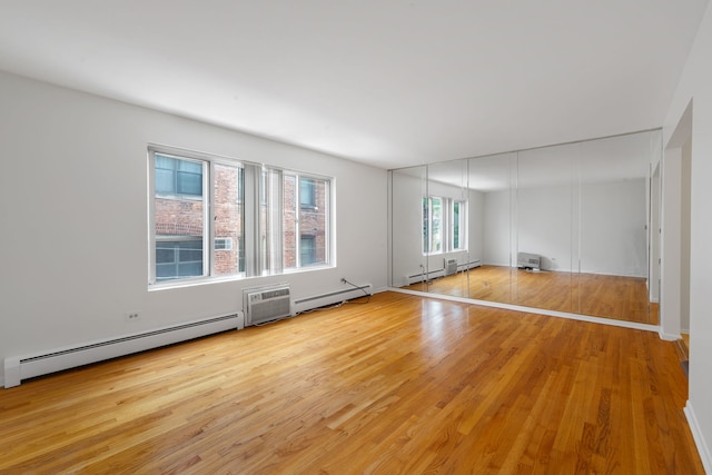950 Washington Blvd Unit 206, Oak Park, IL 60302 - unfurnished room with baseboard heating, light wood-style flooring, and a wall mounted AC
