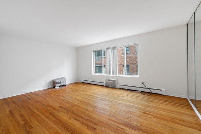 950 Washington Blvd Unit 206, Oak Park, IL 60302 - unfurnished room with a baseboard heating unit and light wood-type flooring