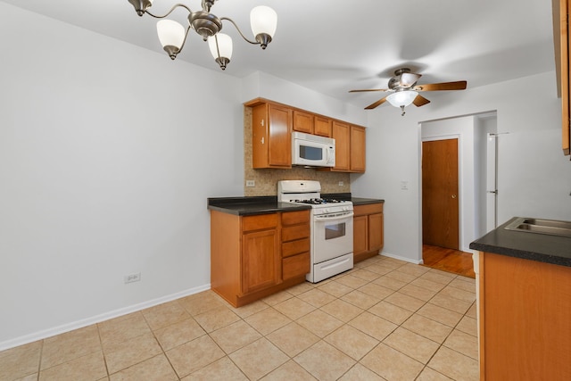 950 Washington Blvd Unit 206, Oak Park, IL 60302 - kitchen with white appliances, a chandelier, dark countertops, tasteful backsplash, and ceiling fan
