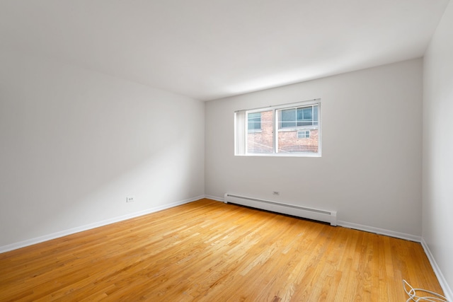950 Washington Blvd Unit 206, Oak Park, IL 60302 - unfurnished room with a baseboard heating unit and light wood-type flooring