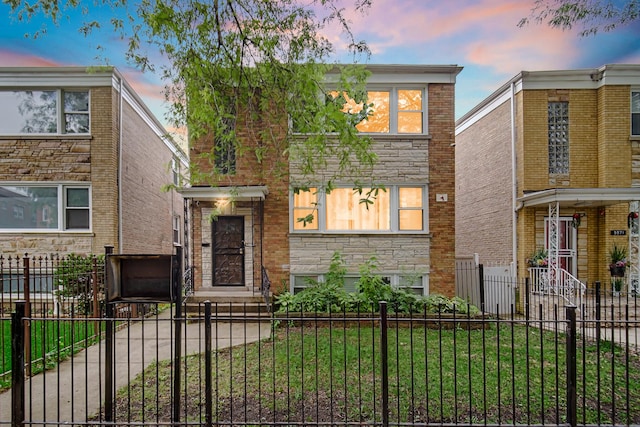 5567 W Gladys Ave, Chicago, IL 60644 - view of front of property featuring a fenced front yard and stone siding
